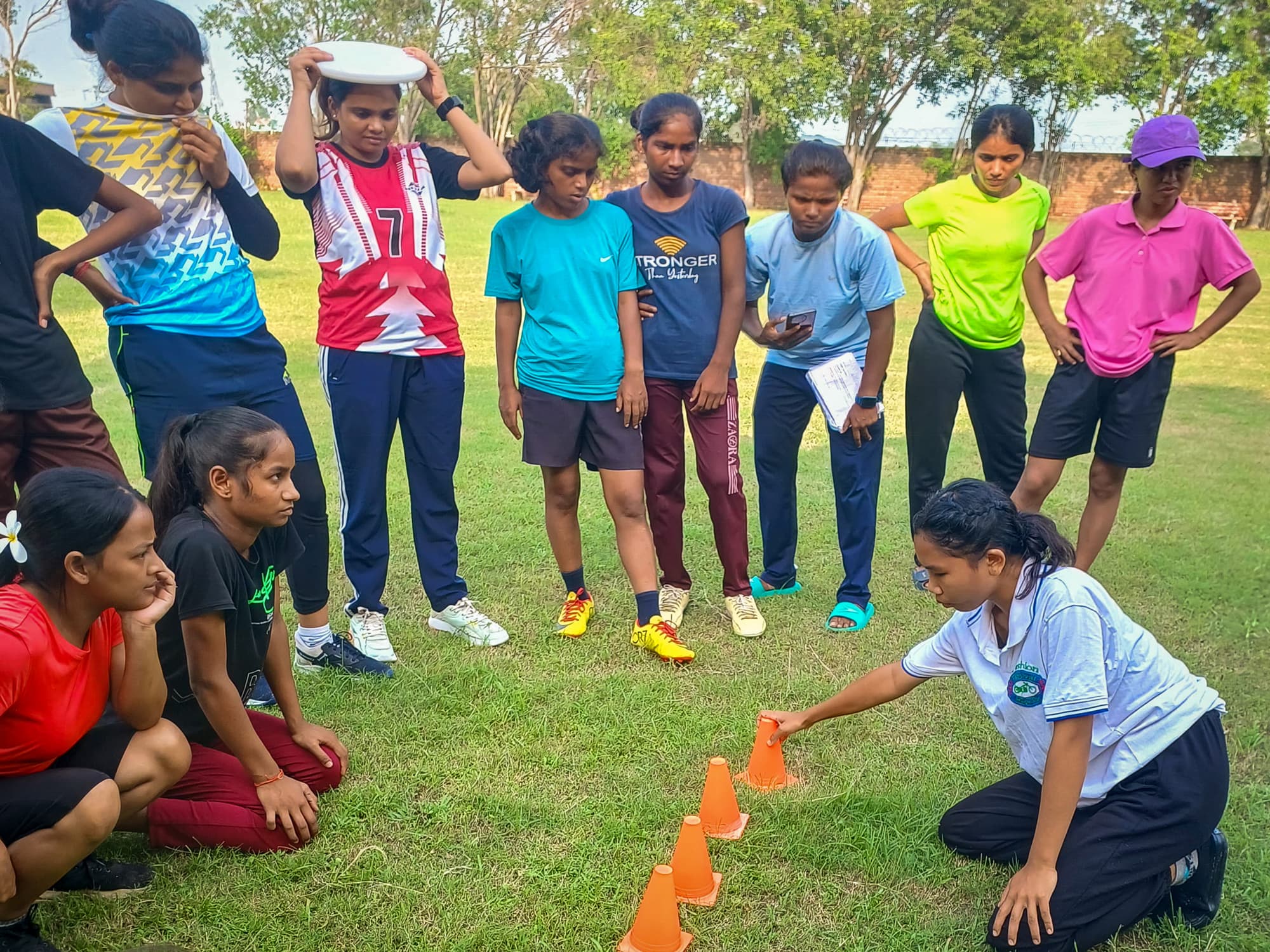 Young woman leading a lesson in ultimate frisbee strategy